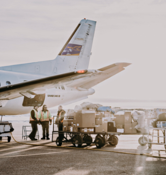People packing cargo into a plane